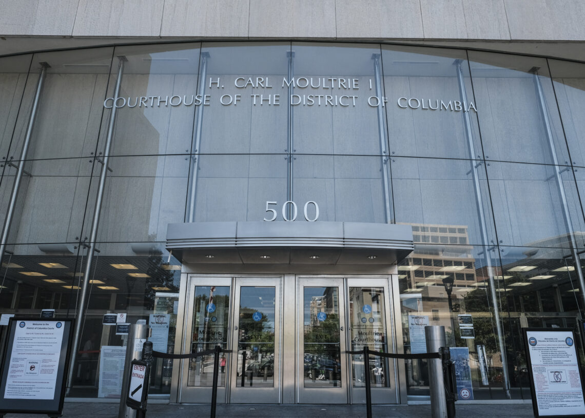 She was arrested and faced charges for months, but her twin was the suspect, suit says