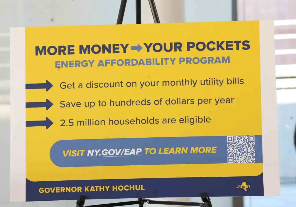 A yellow and blue sign announcing the Energy Affordability Program (EAP) which offers discounts on utility bills.
