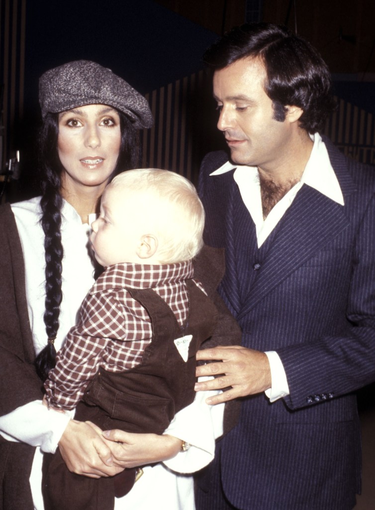 Cher holding her son Elijah Blue Allman alongside Stanley Siegel.