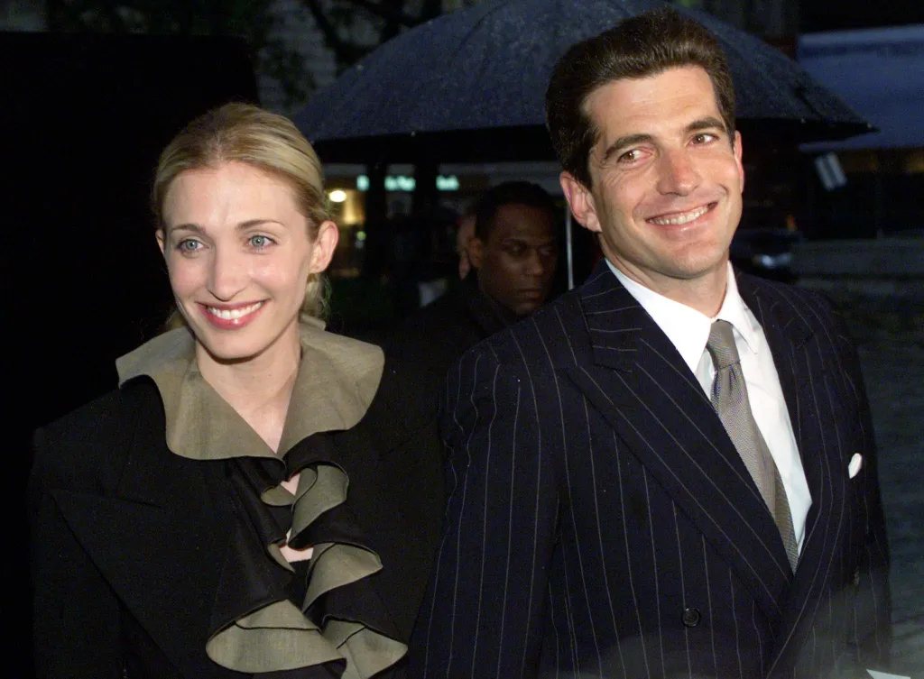 John F. Kennedy Jr. and Carolyn Bessette Kennedy smiling.