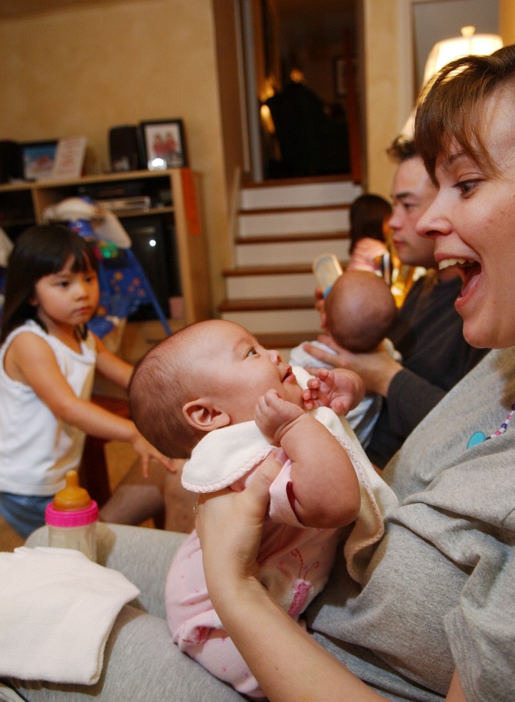 Kate Gosselin reacts to smiling daughter Hannah while Jonathan Gosselin feeds son Collin.