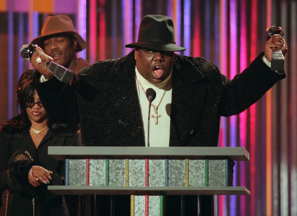 Notorious B.I.G. on stage with two awards.
