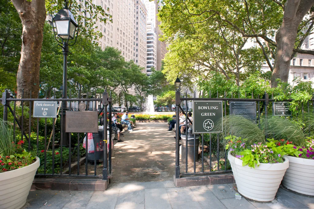 People relax at Bowling Green Park in New York City.