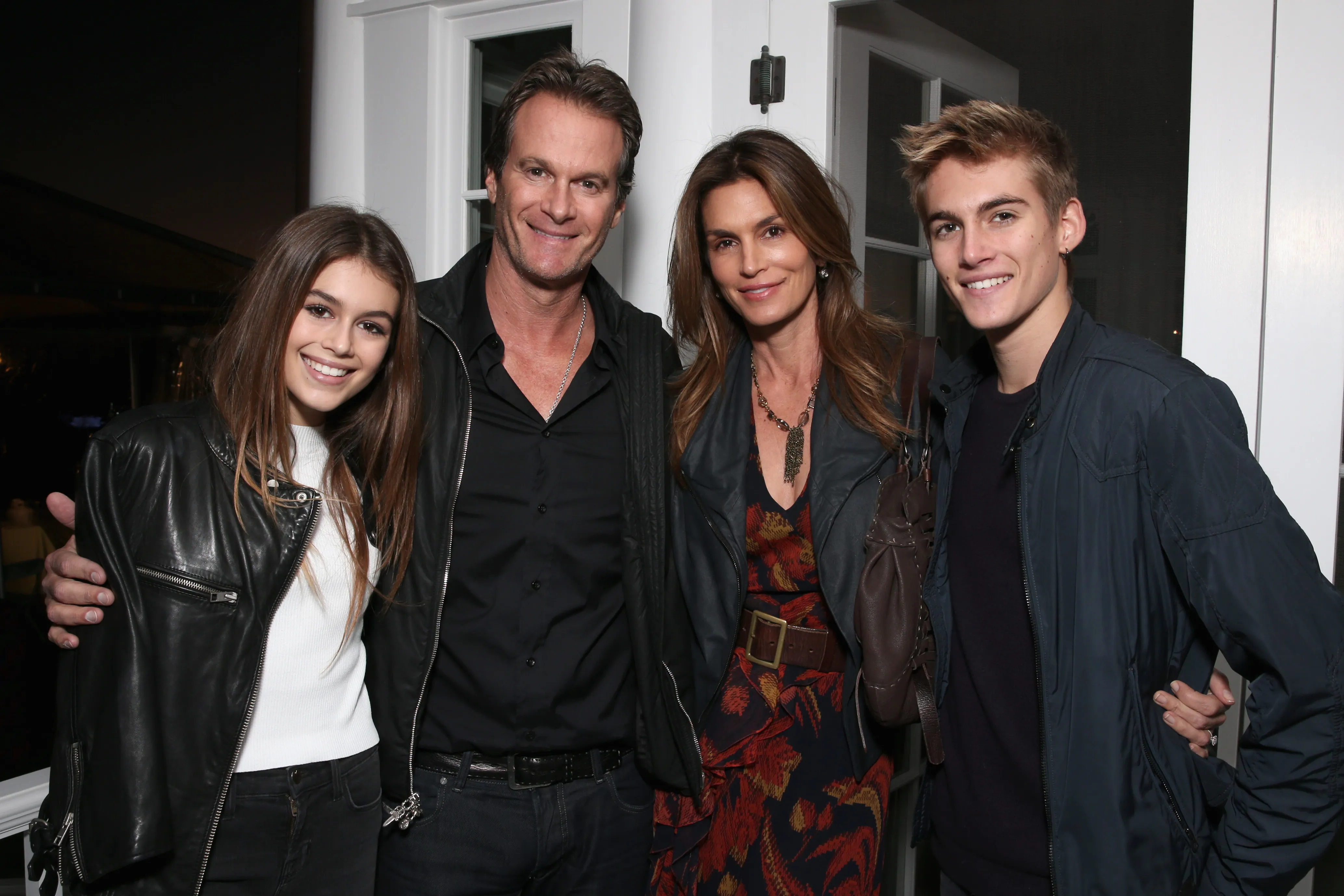 Kaia Gerber, Rande Gerber, Cindy Crawford, and Presley Gerber posing together at an event.