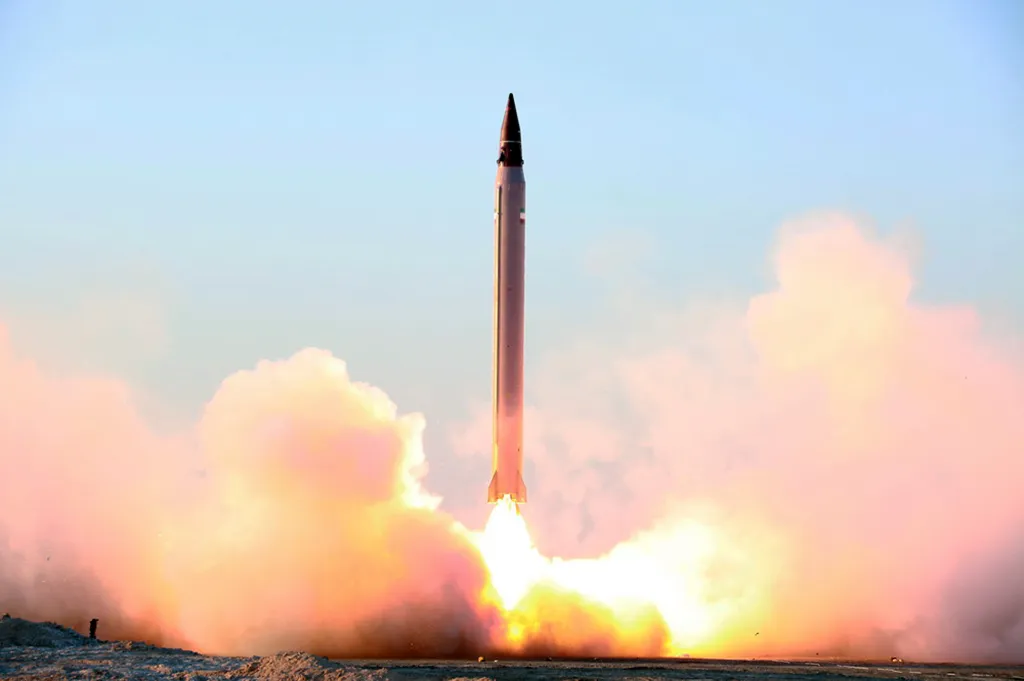 A ballistic missile launching from the ground, with fire and smoke billowing from its base.