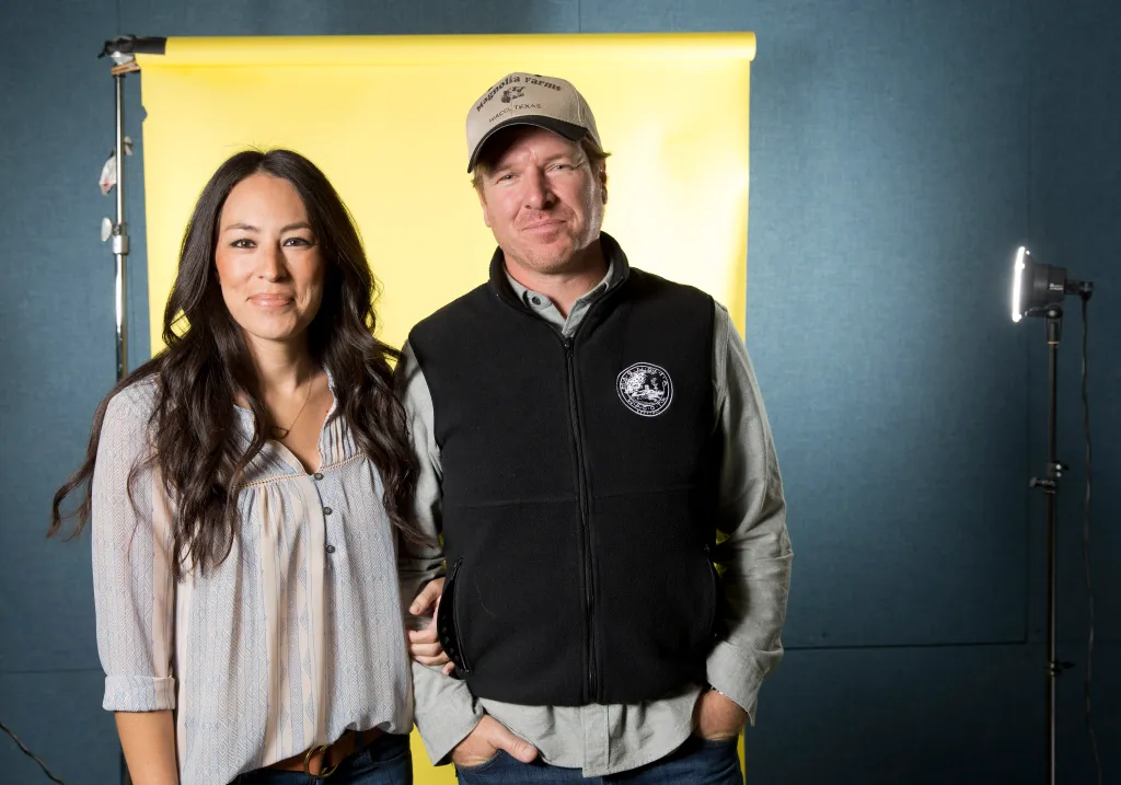 Joanna Gaines and Chip Gaines pose for a portrait.