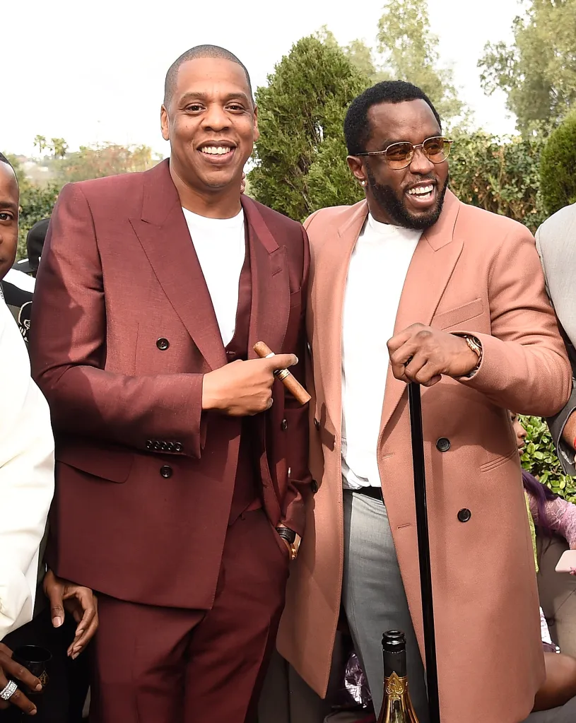 Jay Z and Sean Combs smiling outdoors.