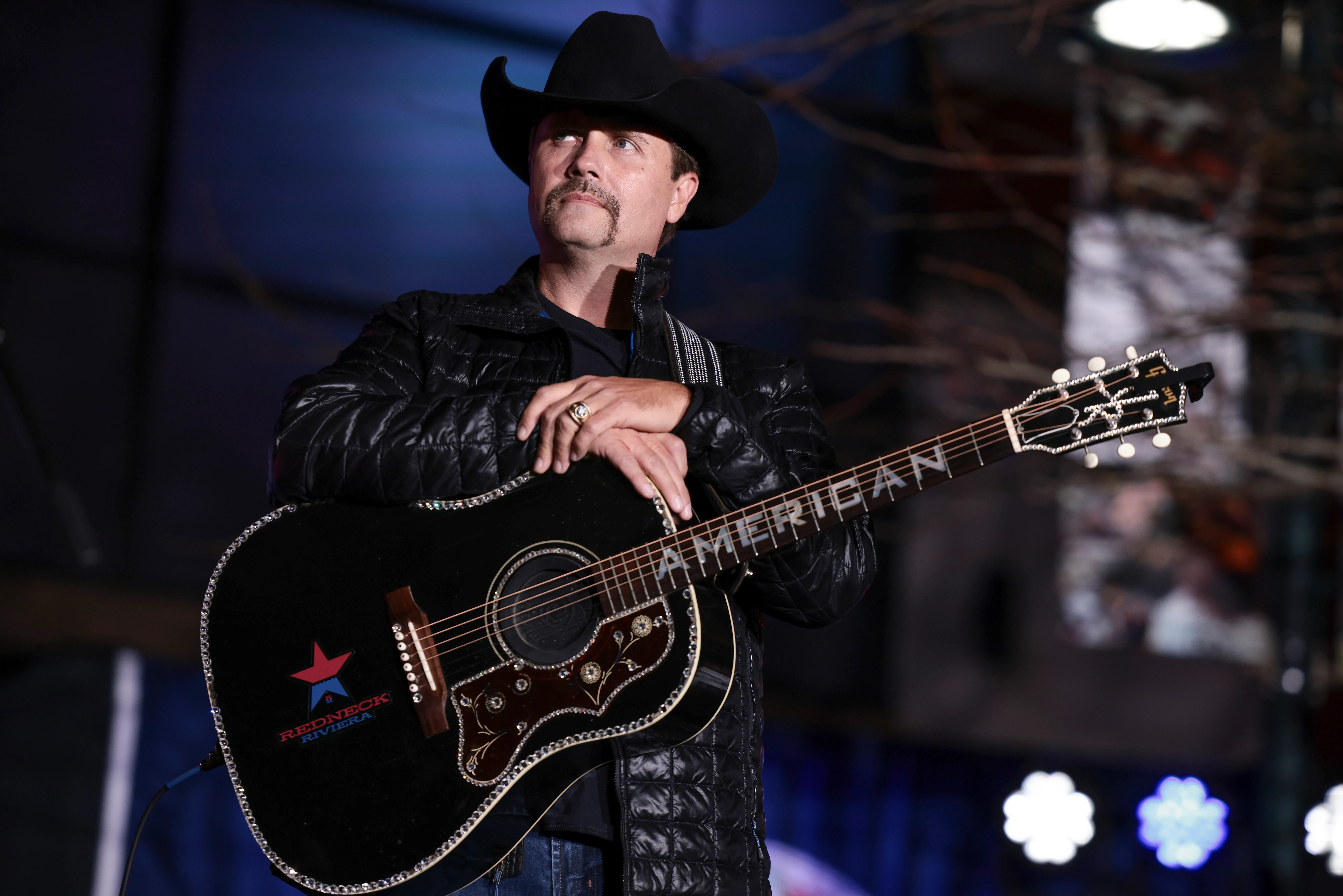 Country singer John Rich looks on as Virginia Republican gubernatorial candidate Glenn Youngkin speaks at a concert for his campaign on October 27, 2021 in Blacksburg, Virginia.