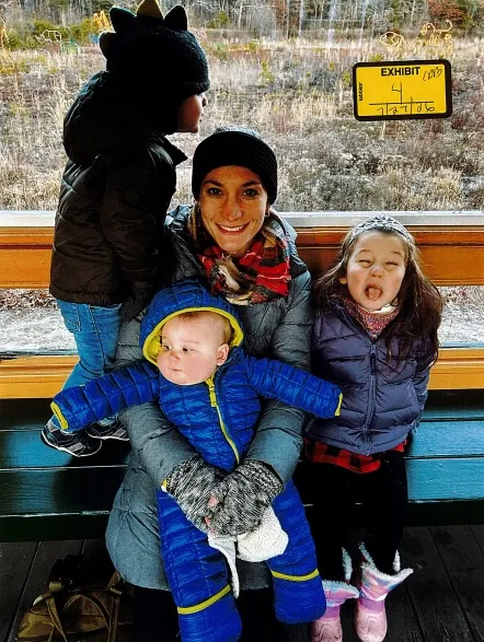 Clancy poses with her children Dawson, left, Callan, center, and Cora, right, in late November 2022.