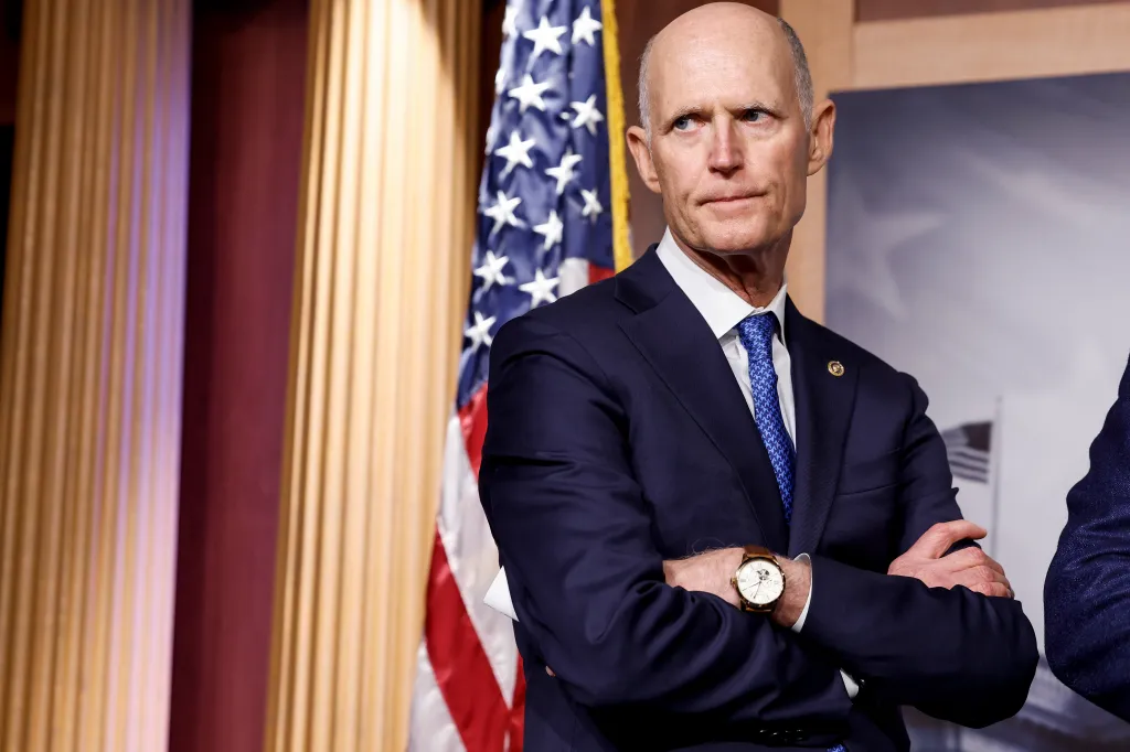 Senator Rick Scott listening at a press conference about the national debt ceiling.