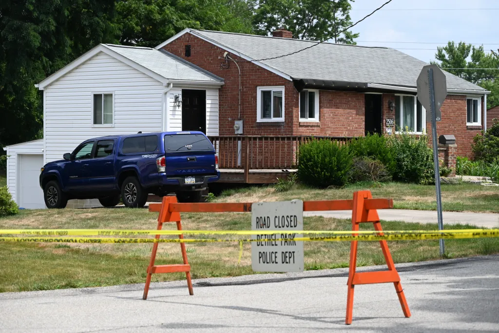 A street sign and crime scene tape near the cordoned-off home of Thomas Matthew Crooks in Bethel Park, Pennsylvania.