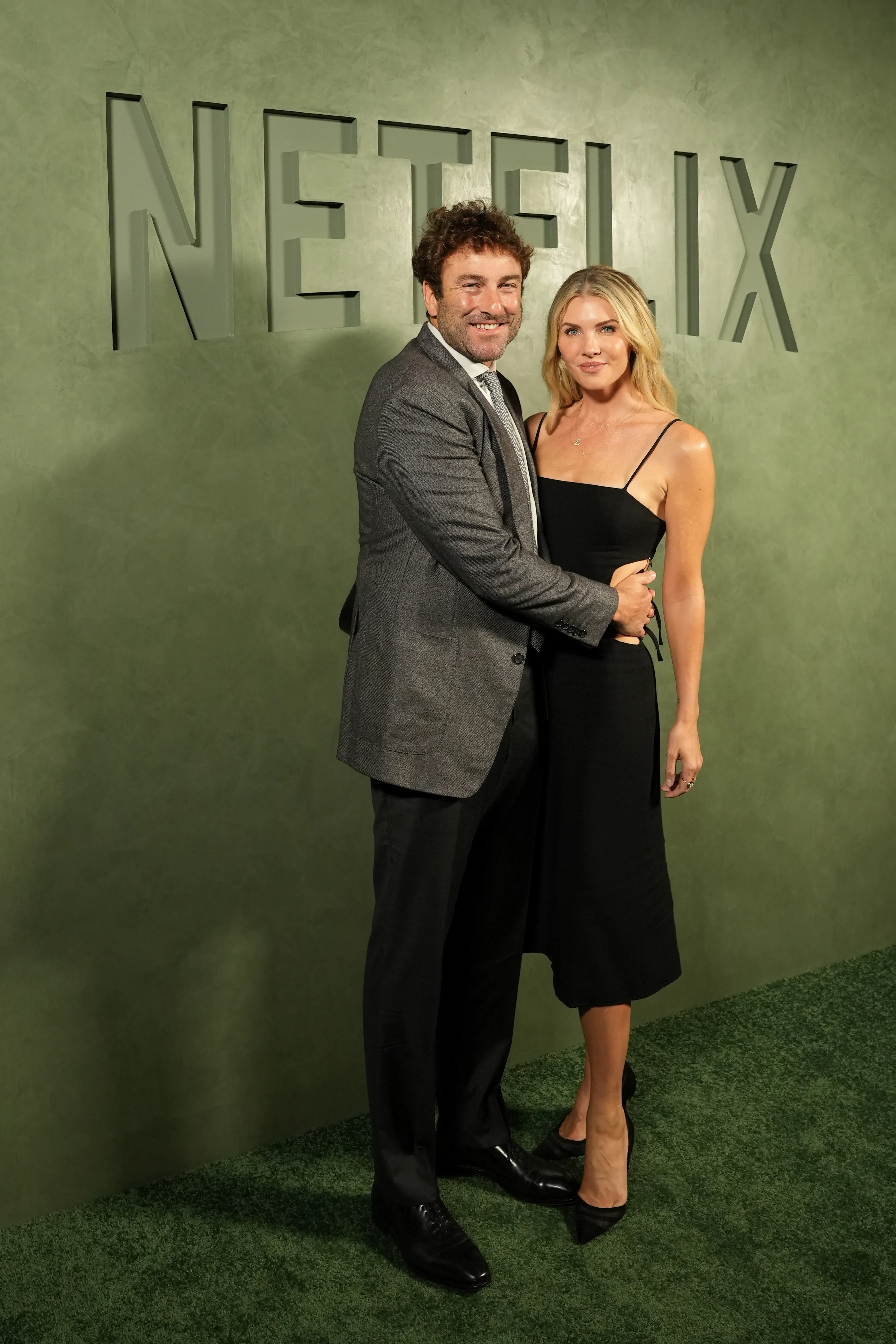 Justin Gimelstob and Amanda Kloots posing together at Netflix's 2025 Emmy Celebration.