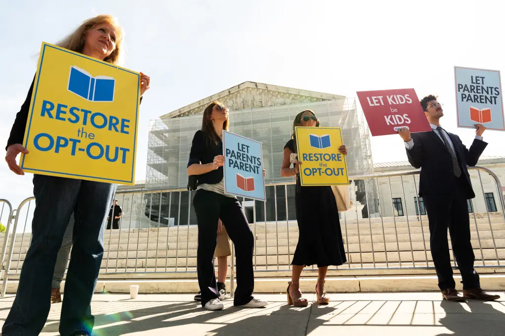 People protest outside the Supreme Court with signs saying 