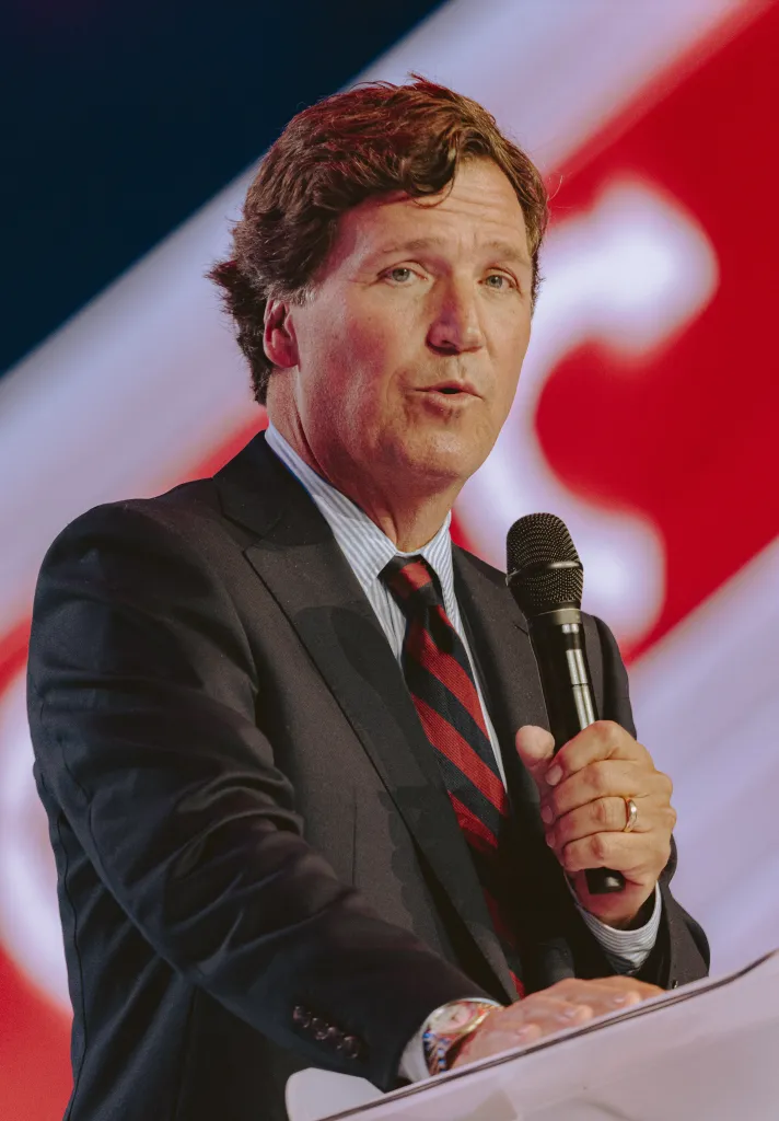 Tucker Carlson speaking at Turning Point's annual AmericaFest conference.