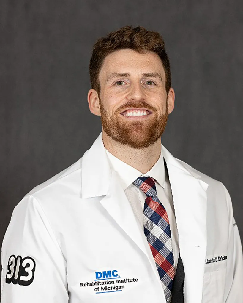 A doctor with a beard in white coat.
