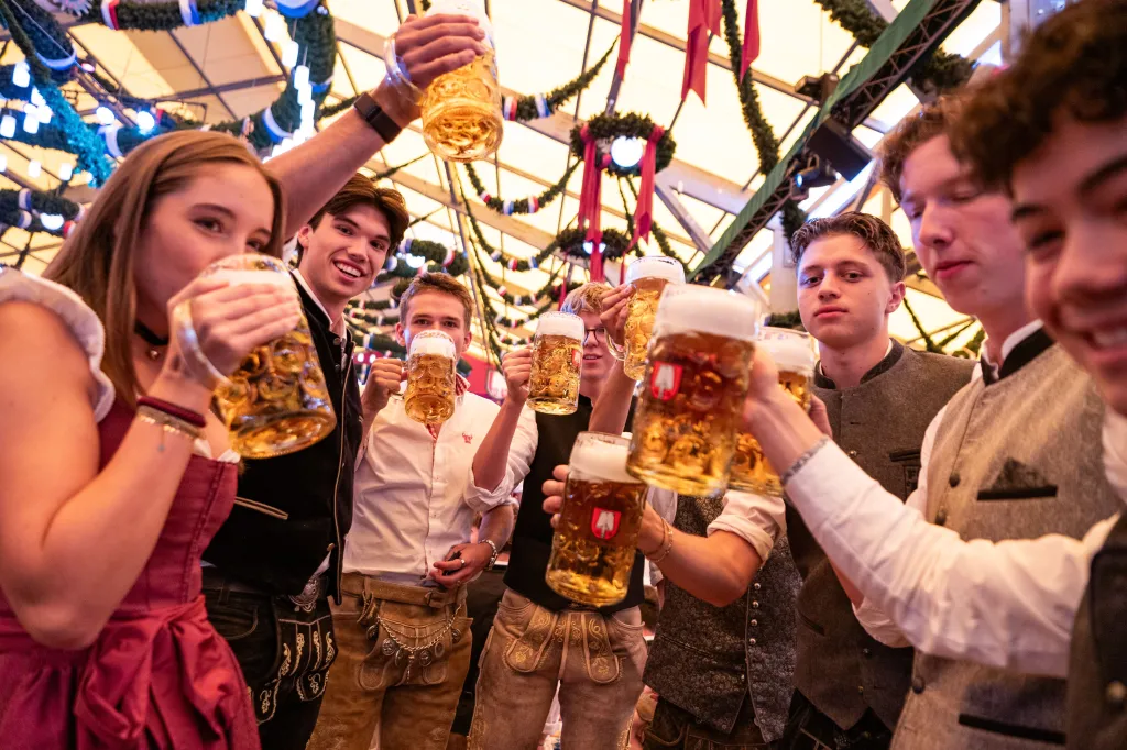 A group of people enjoying beer at the Oktoberfest.