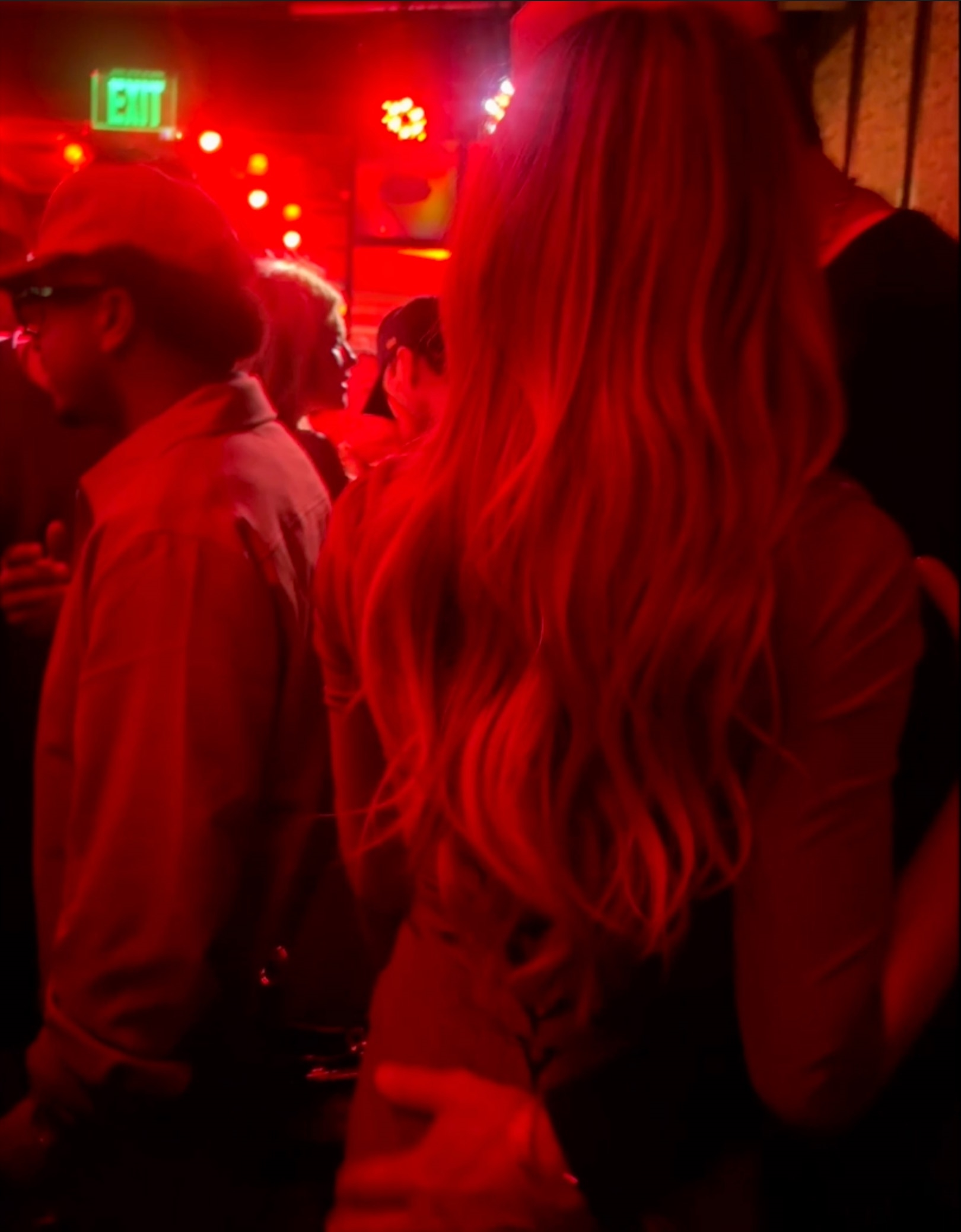 Tom Brady wraps his arm around Alix Earle at a Super Bowl party.