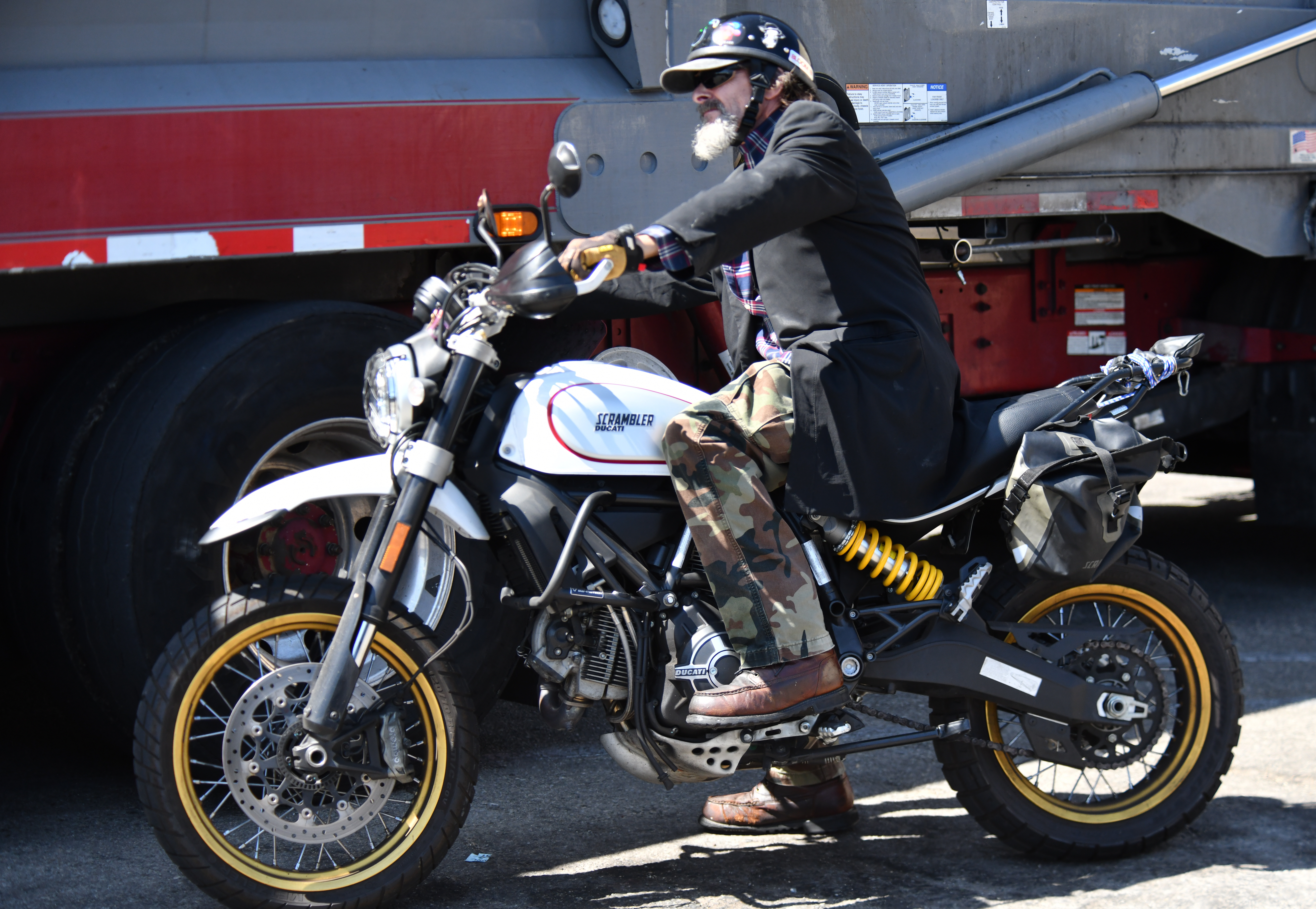 Judd Nelson on a white Ducati Scrambler motorcycle in West Hollywood.