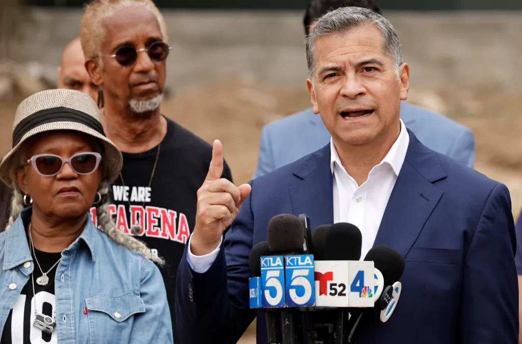 California gubernatorial candidate Xavier Becerra speaks to the media alongside Eaton Fire survivors Gayle and Rasheed Ali in Altadena, California.