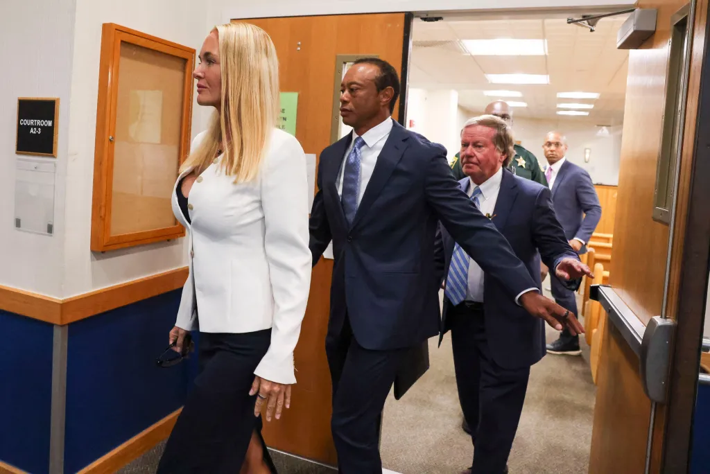 Tiger Woods and Vanessa Trump leaving a courtroom.