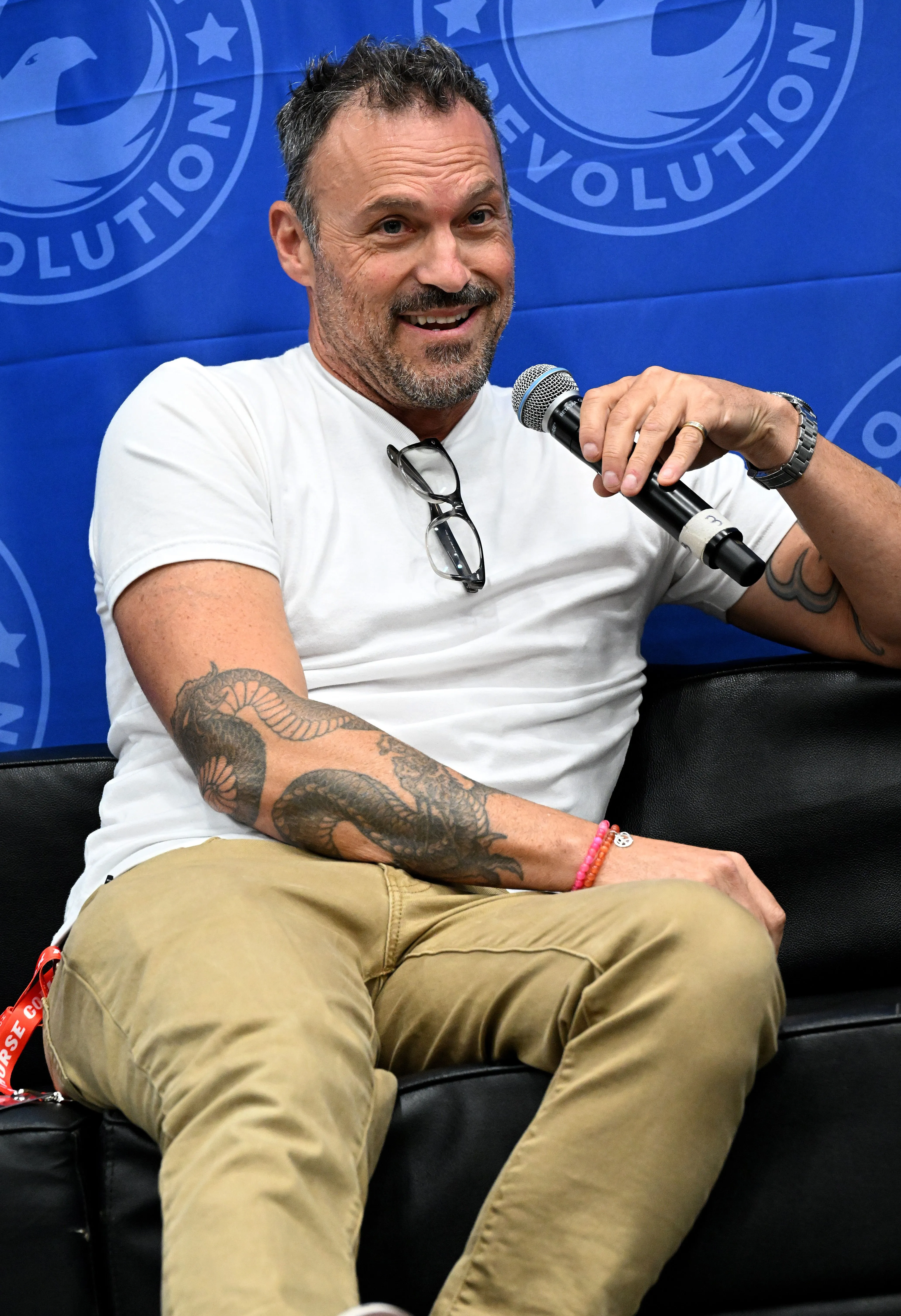 Brian Austin Green speaking into a microphone.