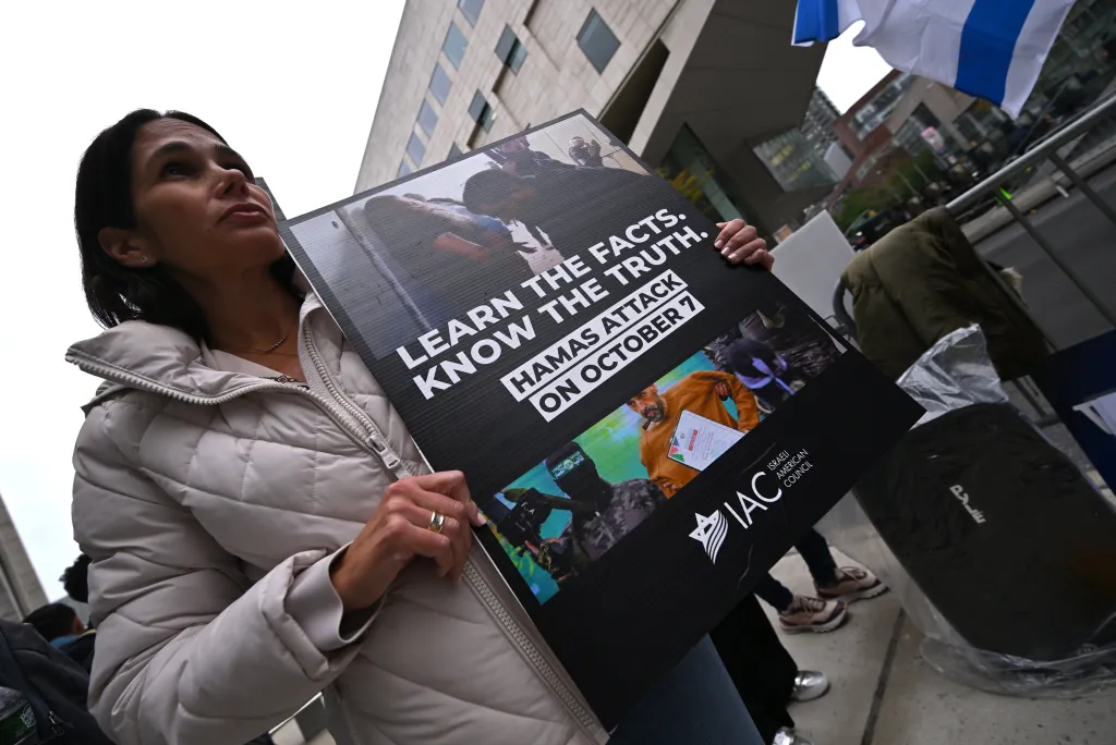 A protester holds a sign that reads