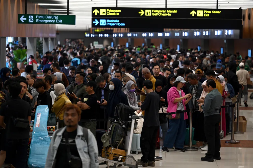 Travelers wait in line at Soekarno-Hatta International Airport after it was temporarily closed due to volcanic ash.