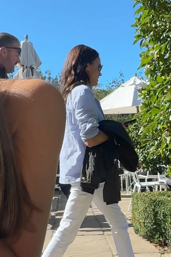 Meghan Markle walking at The Three Horseshoes pub.
