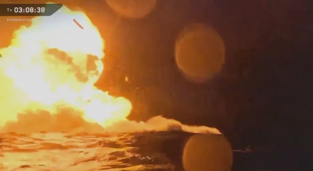The SpaceX Starship making a fiery landing on the water during its 14th test flight.