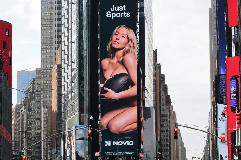 An ad featuring actress Sydney Sweeney holding a football while appearing undressed is displayed in Times Square, New York City.
