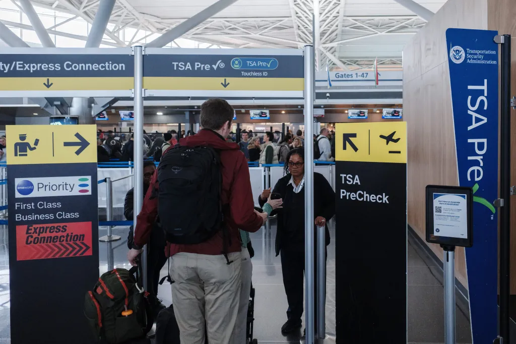 People pass through a TSA Pre-check security checkpoint at John F. Kennedy International Airport.