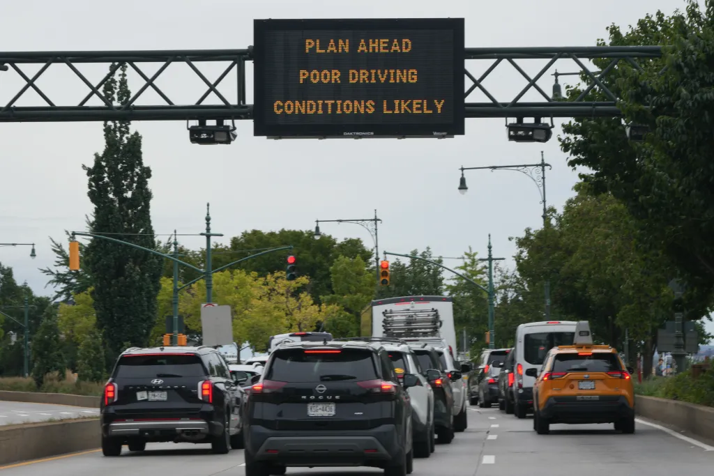 Traffic passes beneath a sign over NYC's West Side Highway warning of high winds and rain over the weekend with the impending arrival of a Nor'easter in the New York metro area.