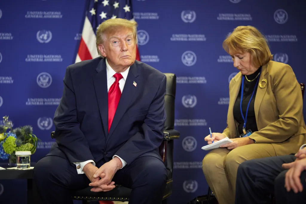 Donald Trump and a woman attend the UN General Assembly.