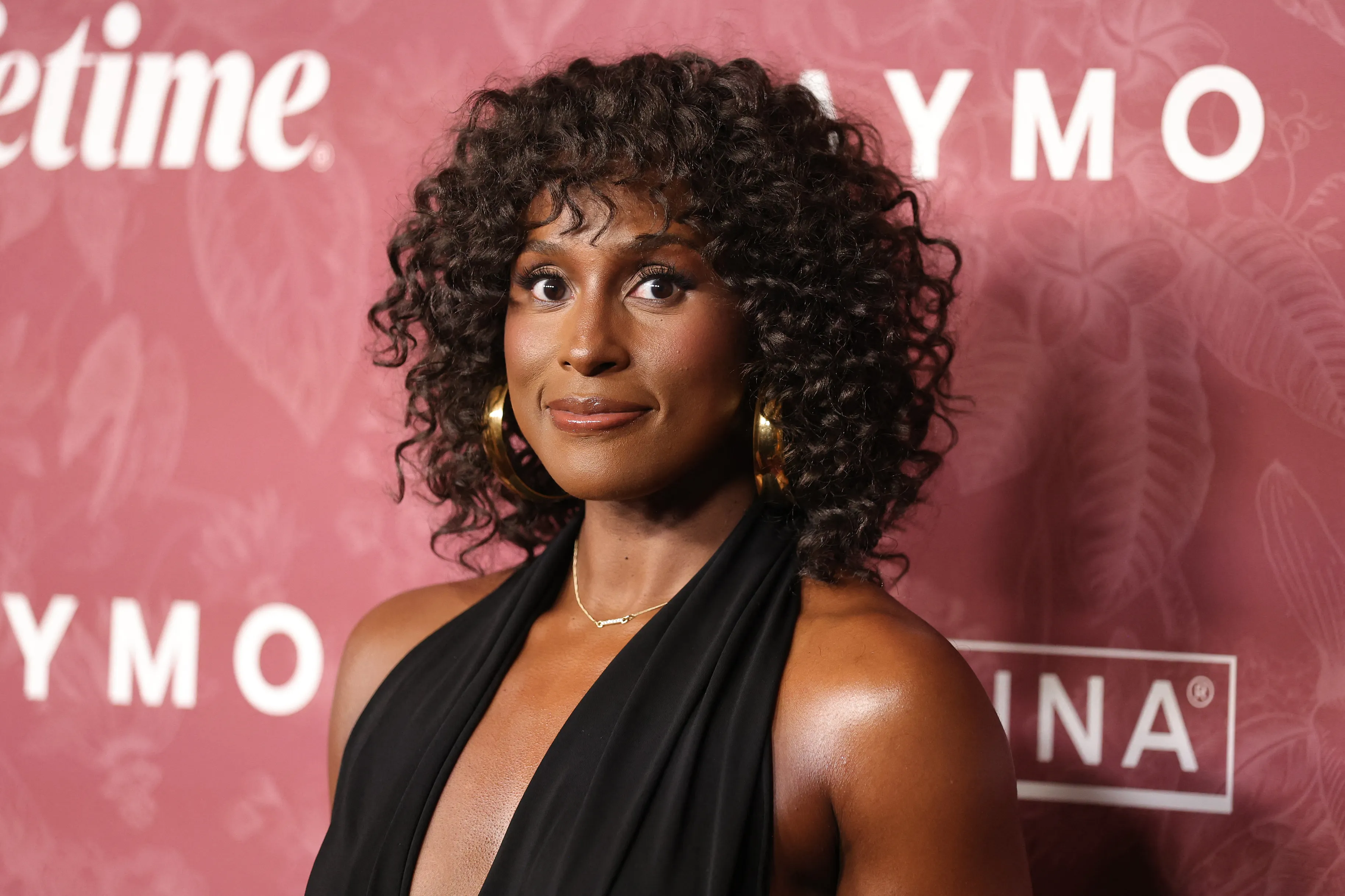Issa Rae in a black dress with gold hoop earrings at the Variety Power of Women event.