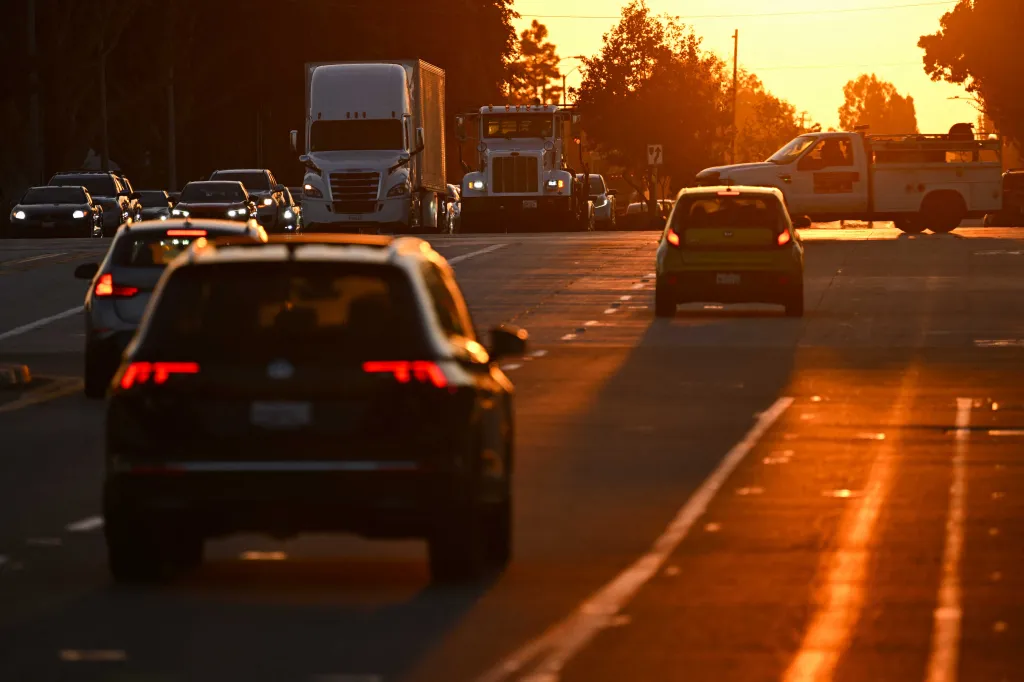 Traffic of cars and trucks at sunset in Carson, California.