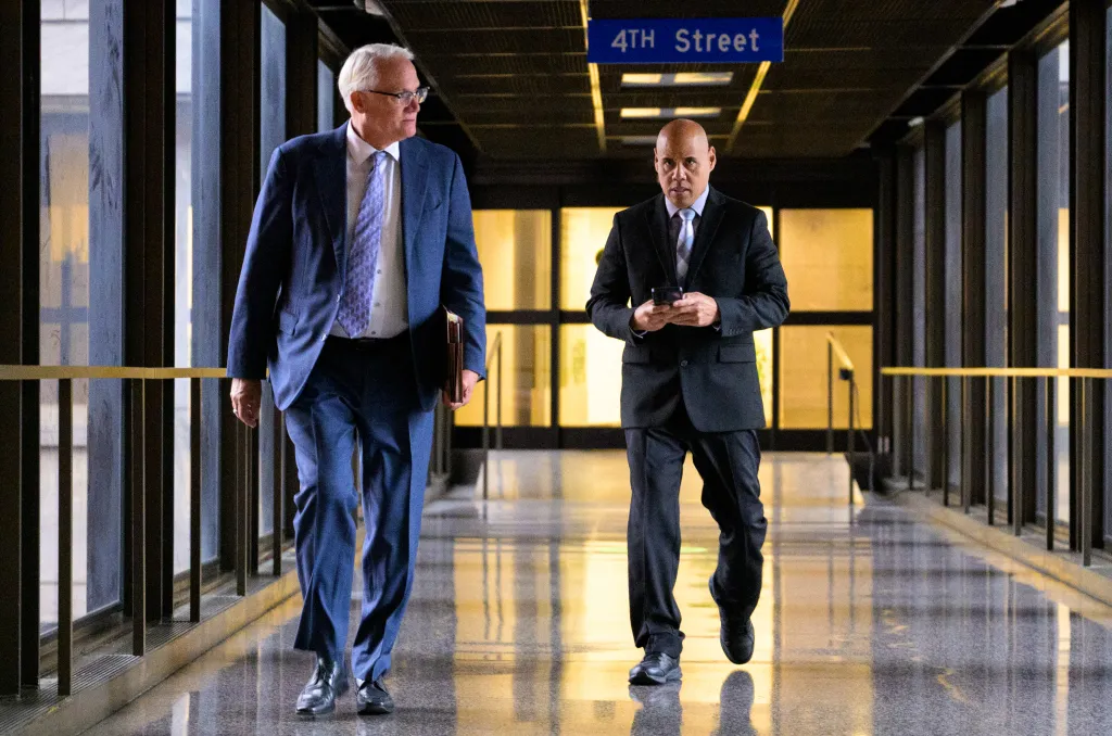 ICE Officer Christian Castro (right) departing the Warren E. Burger Federal Building and U.S. Courthouse.