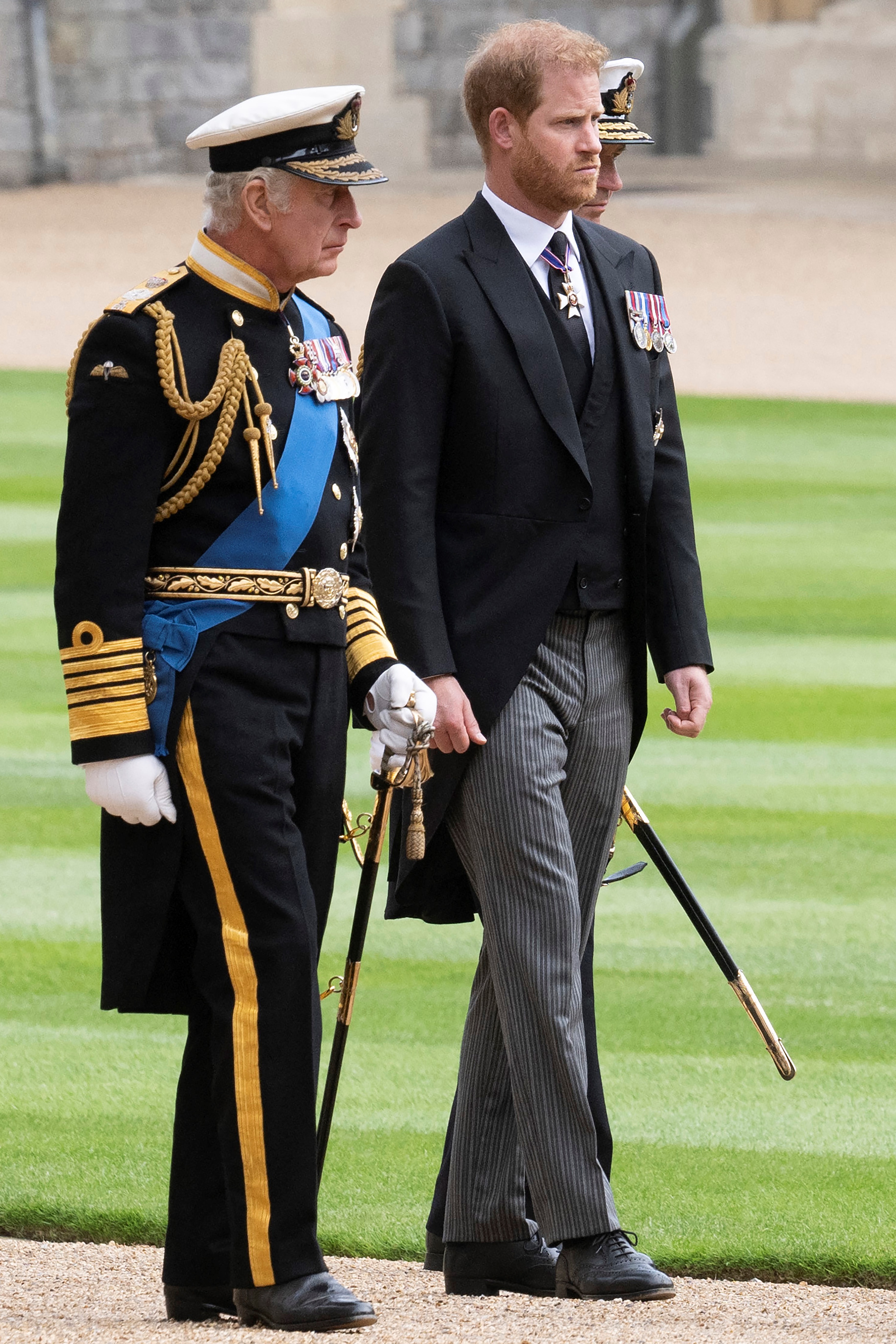  Britain's King Charles III (L) walks with his son Britain's Prince Harry, Duke of Sussex as they arrive at St George's Chapel inside Windsor Castle on September 19, 2022, ahead of the Committal Service for Britain's Queen Elizabeth II. 