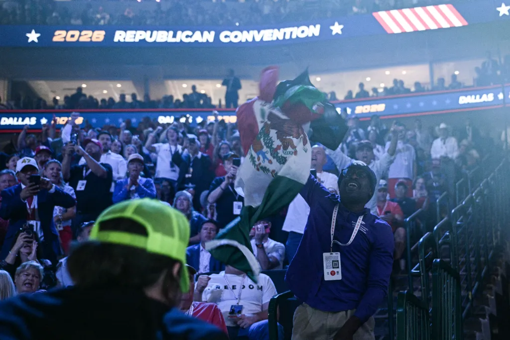 A protestor waving a Mexican flag at the 2026 Republican Convention.
