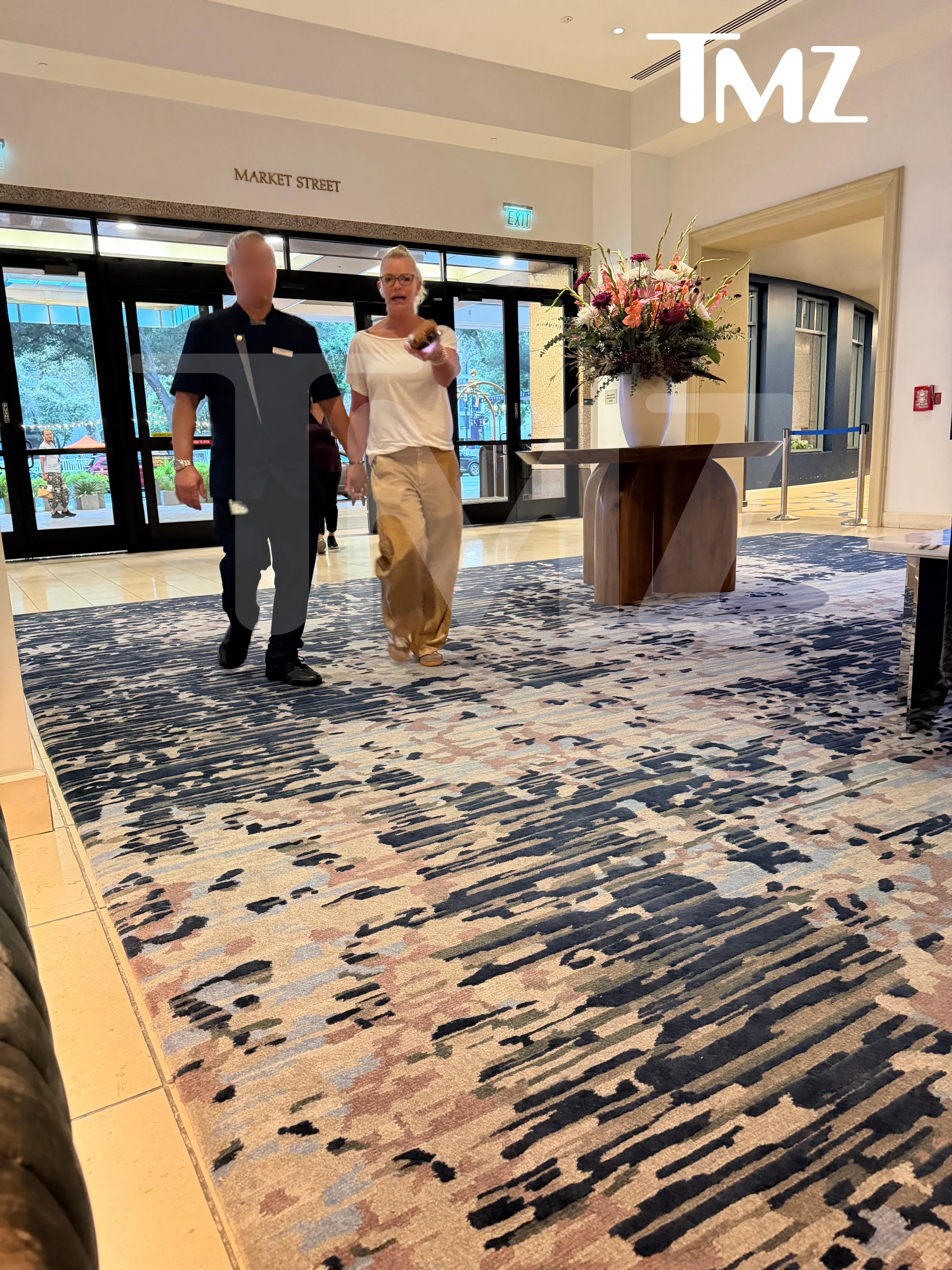 Jaime Pressly being escorted out of a California hotel.