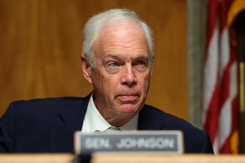 U.S. Sen. Ron Johnson looks on during a business meeting.