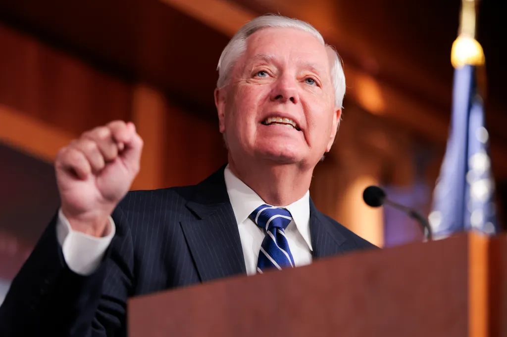U.S. Sen. Lindsey Graham speaking at a press conference, gesturing with a clenched fist.