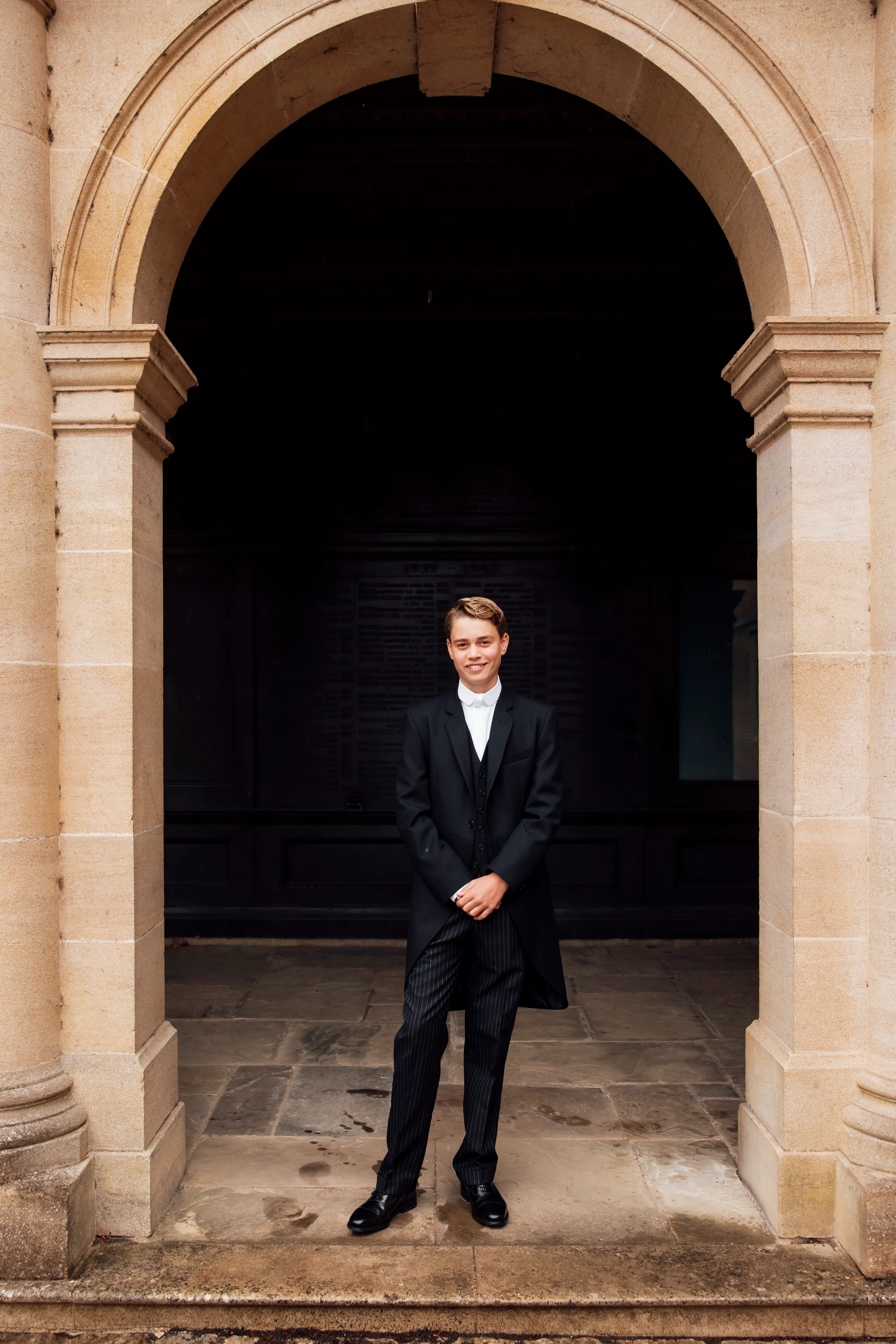 Prince George smiling in his uniform at Eton College.