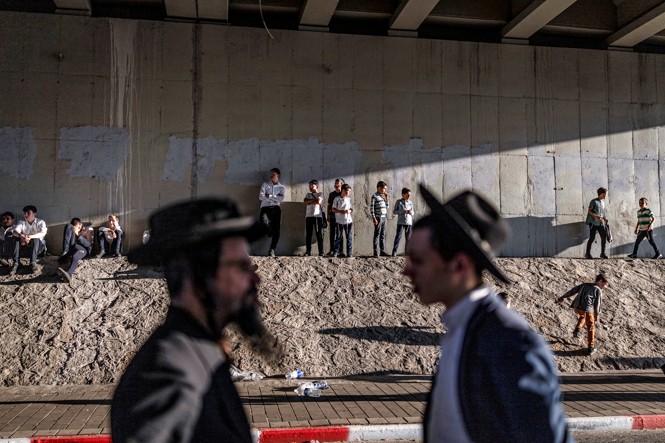 Ultra-Orthodox Jewish men block a road during a protest against military conscription