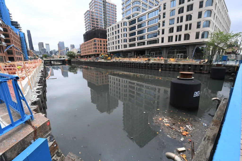 A picture of the Gowanus Canal with debris in it.