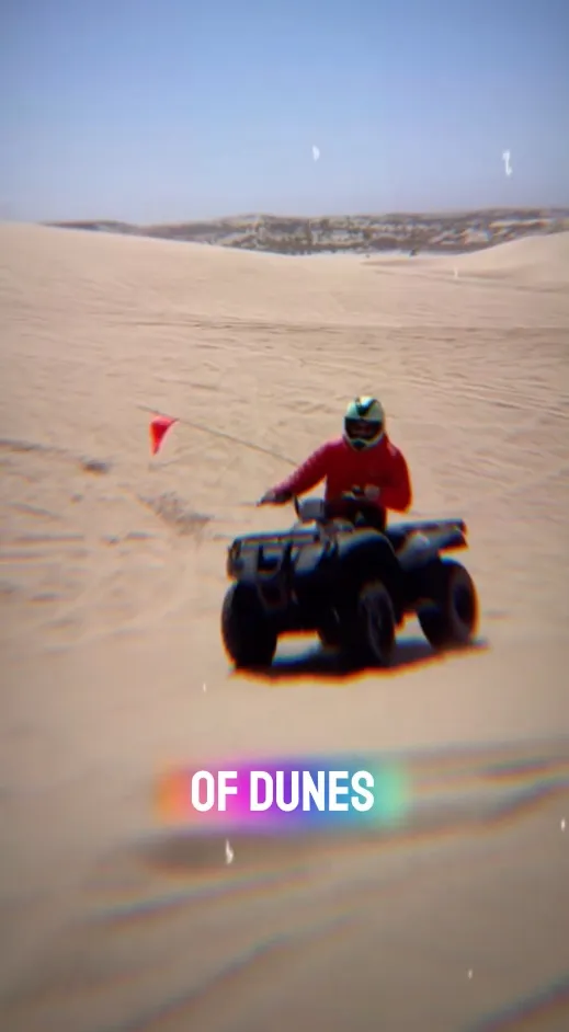 Person on an ATV in the Oceano Dunes.