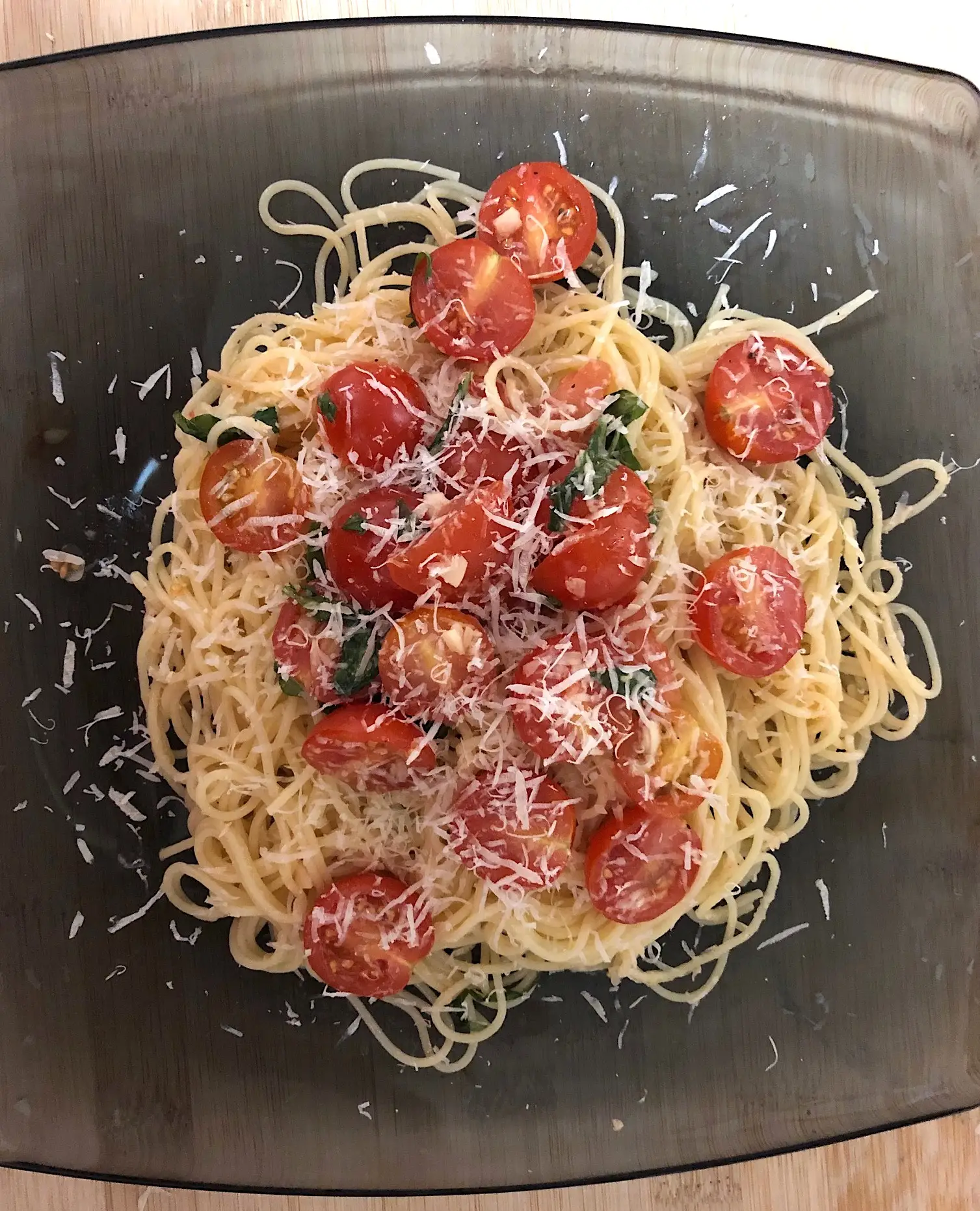 A spagetti dish with fresh tomatoes.