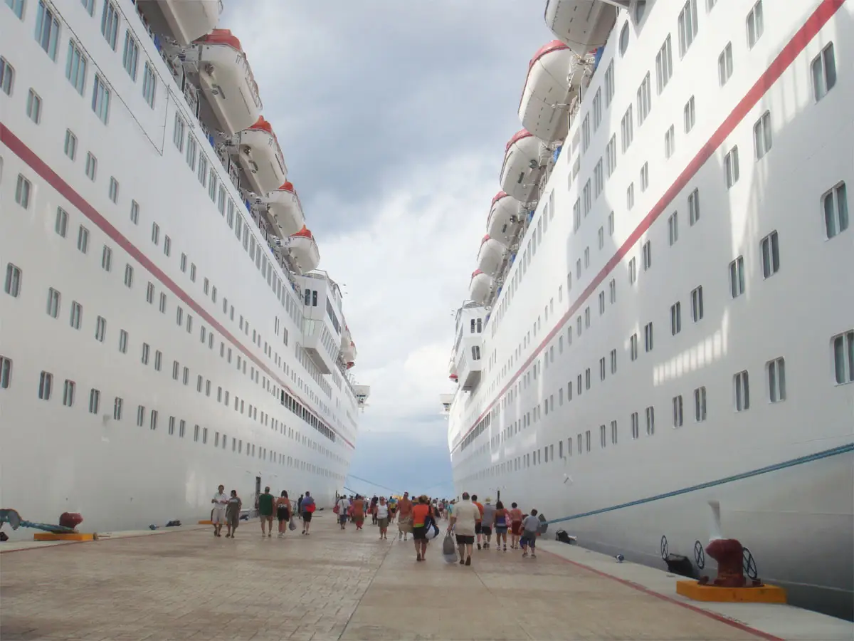 people walking between two cruise ships