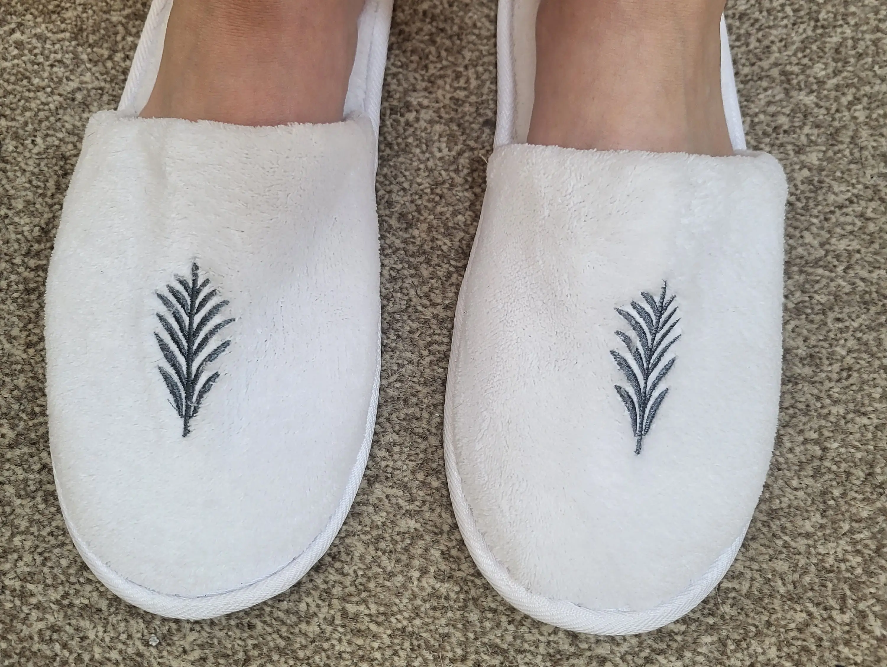 Woman wearing white slippers
