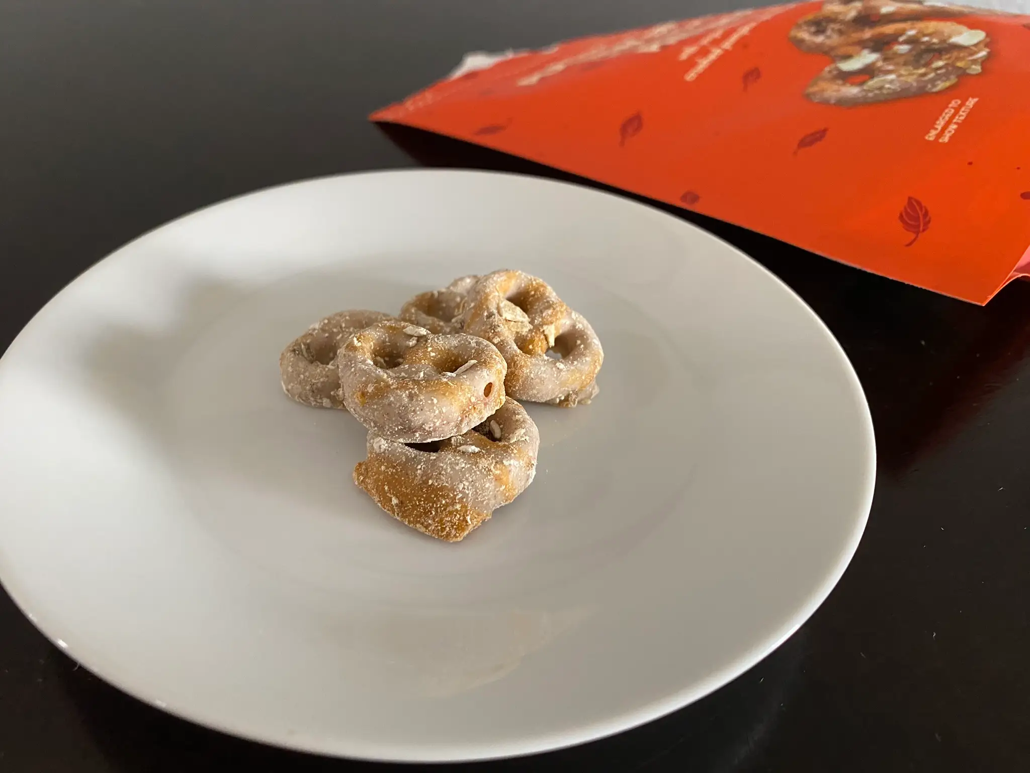 pumpkin cream covered pretzels on white plate