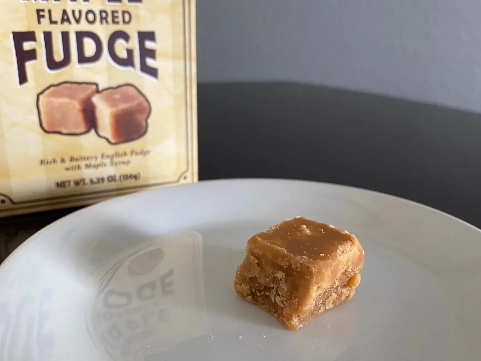 cube of maple-flavored fudge on white plate